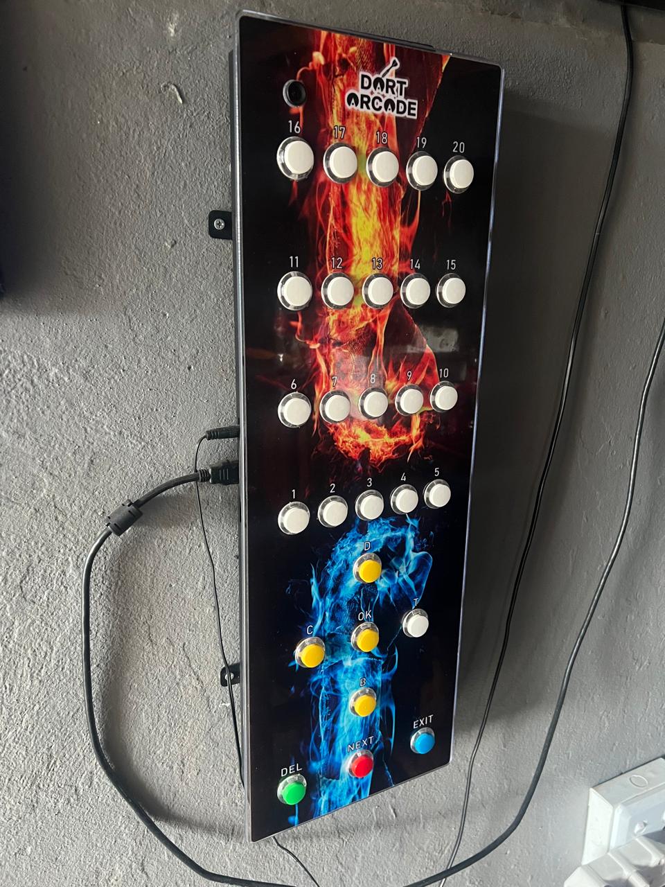 The fourth DartArcade prototype with fire and ice artwork mounted on a wall